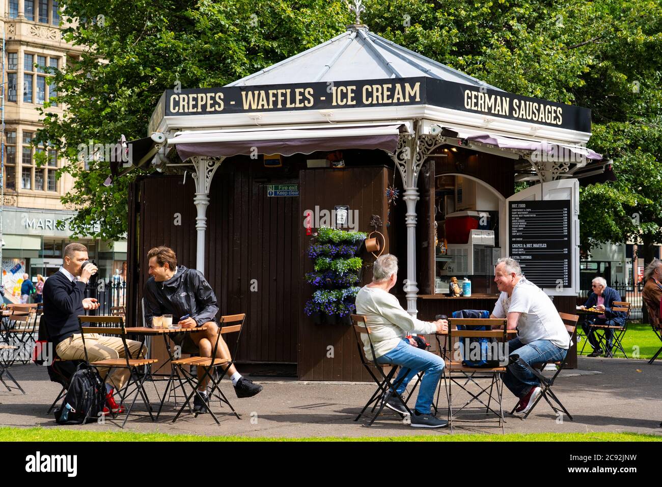 Edinburgh, Scotland, UK. 28 July, 2020. Business and tourism slowly returning to the shops and streets of Edinburgh city centre. The public returning to enjoy cafe inside East Princes Street Gardens which have recently reopened after landscaping and drainage improvement works. Iain Masterton/Alamy Live News Stock Photo