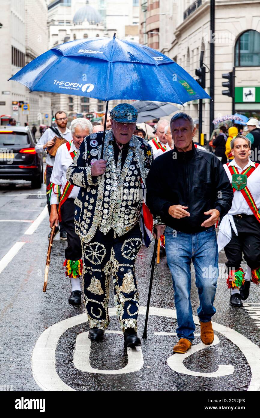 A Pearly King and Chingford Morris Dancers Make Their Way To The Bow Bells Church For The Annual Pearly Kings and Queens Harvest Festival Service, UK Stock Photo