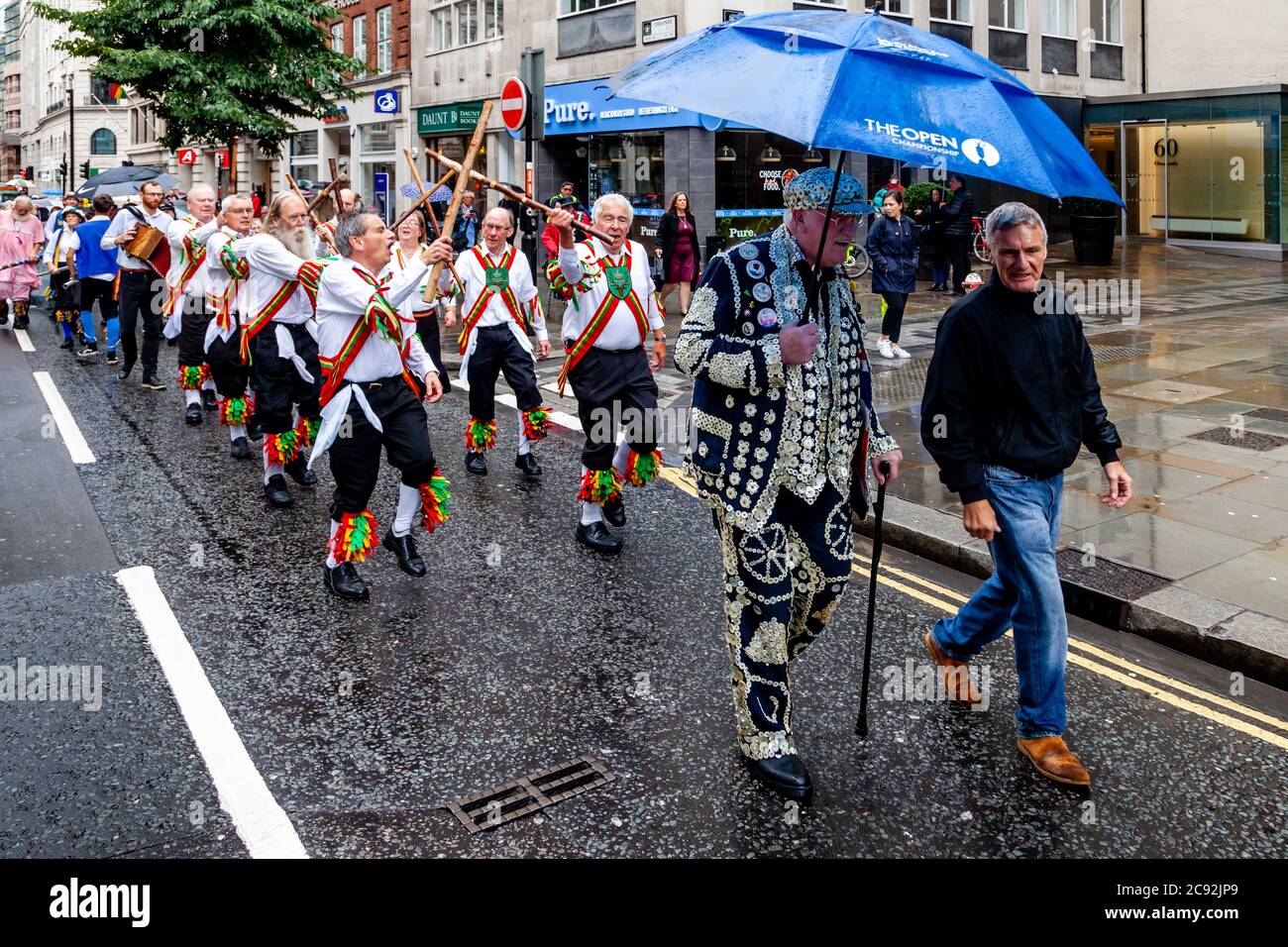A Pearly King and Chingford Morris Dancers Make Their Way To The Bow Bells Church For The Annual Pearly Kings and Queens Harvest Festival Service, UK Stock Photo