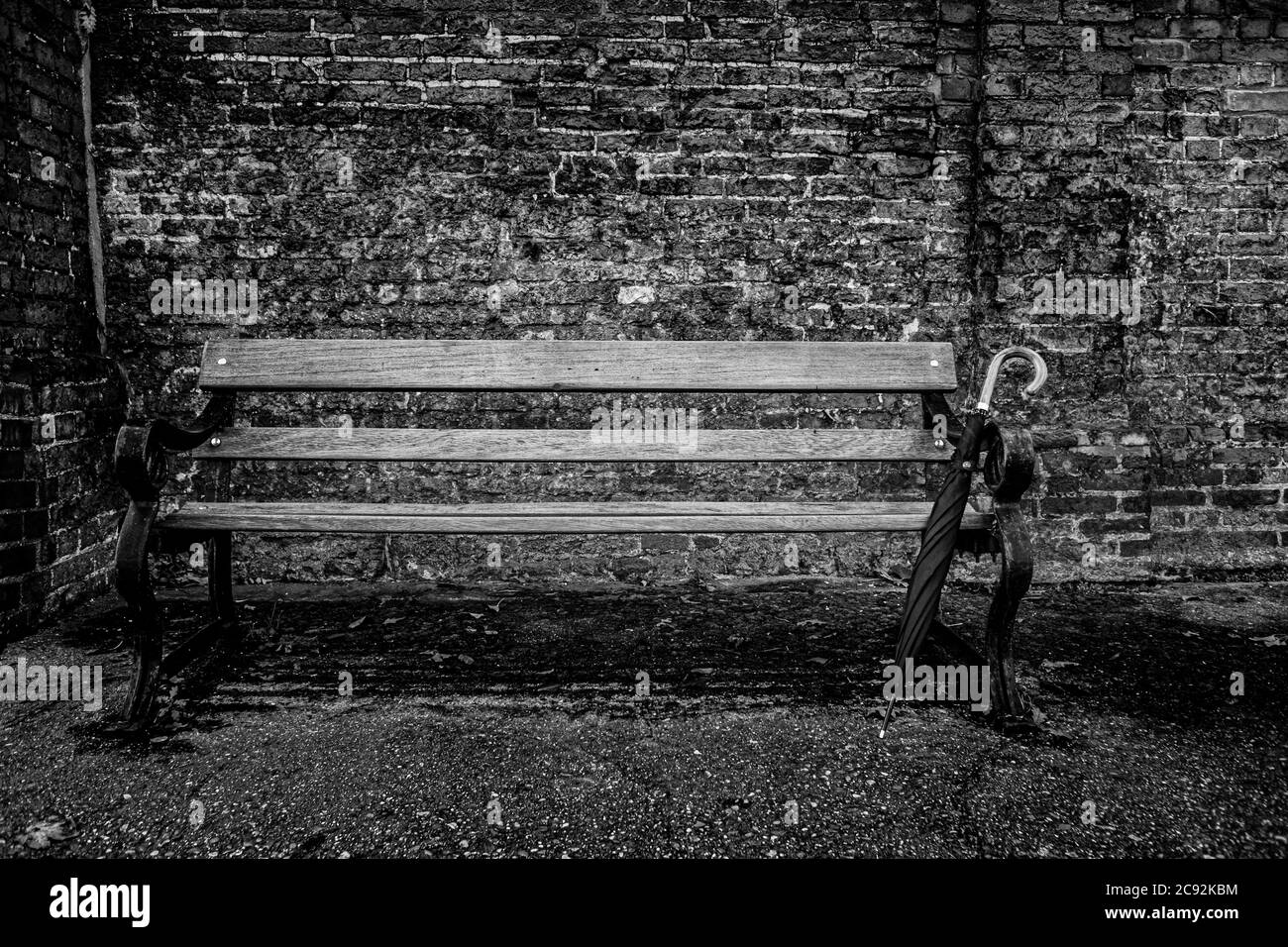 Bench in front of wall Black and White Stock Photos & Images - Alamy