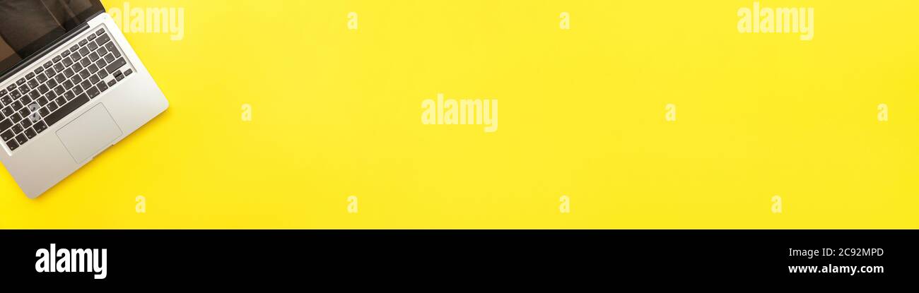 Keyboard laptop computer isolated on yellow desk background. Modern ...