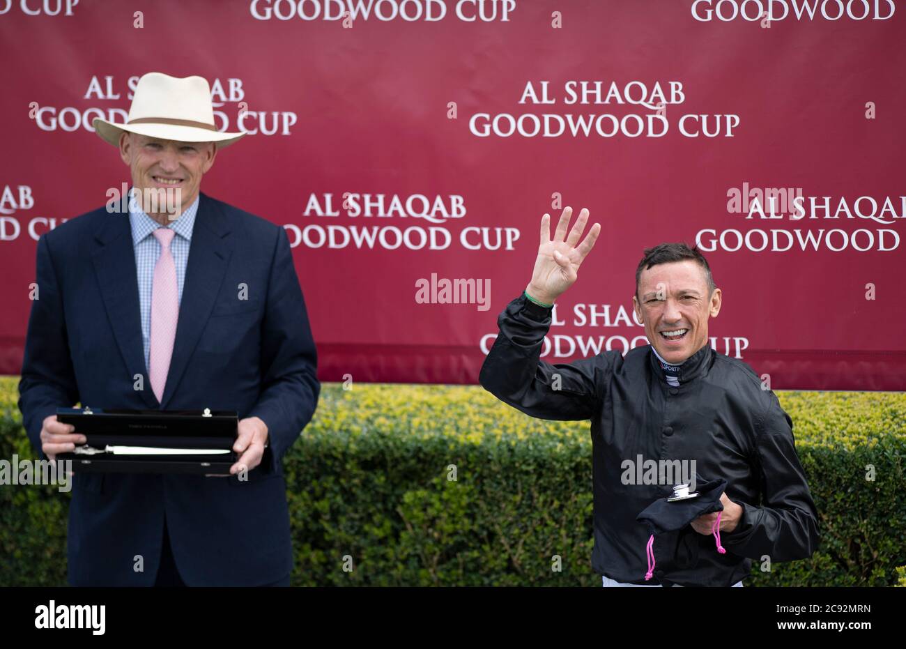 Trainer John Gosden and jockey Frankie Dettori after winning the Al Shaqab Goodwood Cup on Stradivarius during day one of the Goodwood Festival at Goodwood Racecourse, Chichester. Stock Photo
