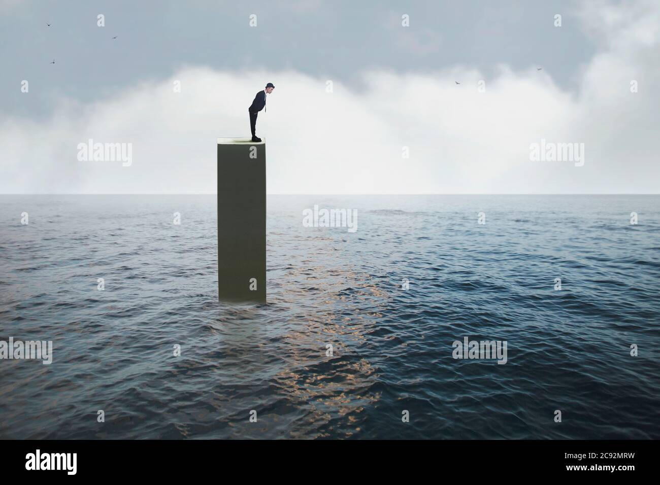 man worried about being on a tower in the middle of the ocean with no escape Stock Photo