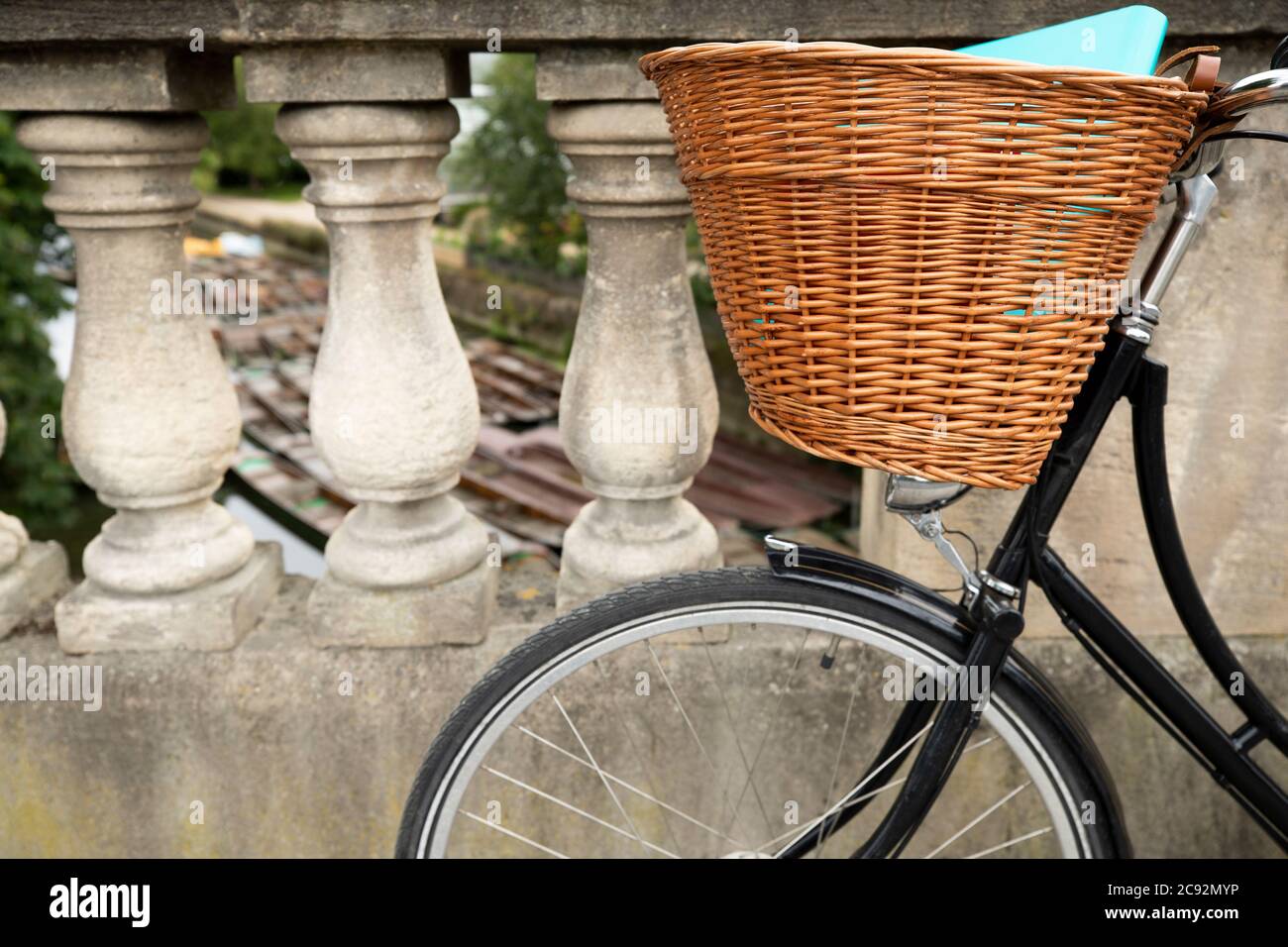 Old Fashioned Bicycle On Magdalen Bridge Over River Cherwell In Oxford With Punts Moored In Background Stock Photo