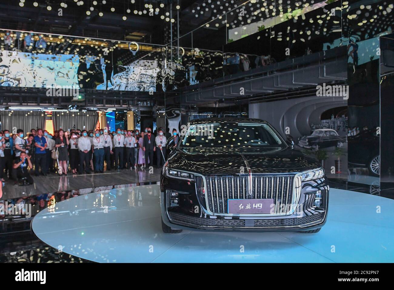 Changchun, China's Jilin Province. 28th July, 2020. Visitors look at the H9 sedan during an event showcasing the products and culture of China's iconic auto brand Hongqi in Changchun, northeast China's Jilin Province, July 28, 2020. Credit: Zhang Nan/Xinhua/Alamy Live News Stock Photo