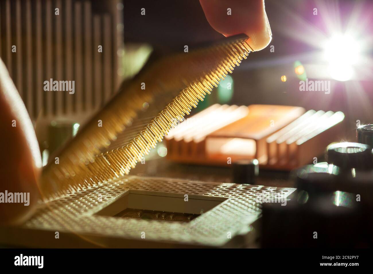 Technician plug in CPU microprocessor to motherboard socket, evident ...