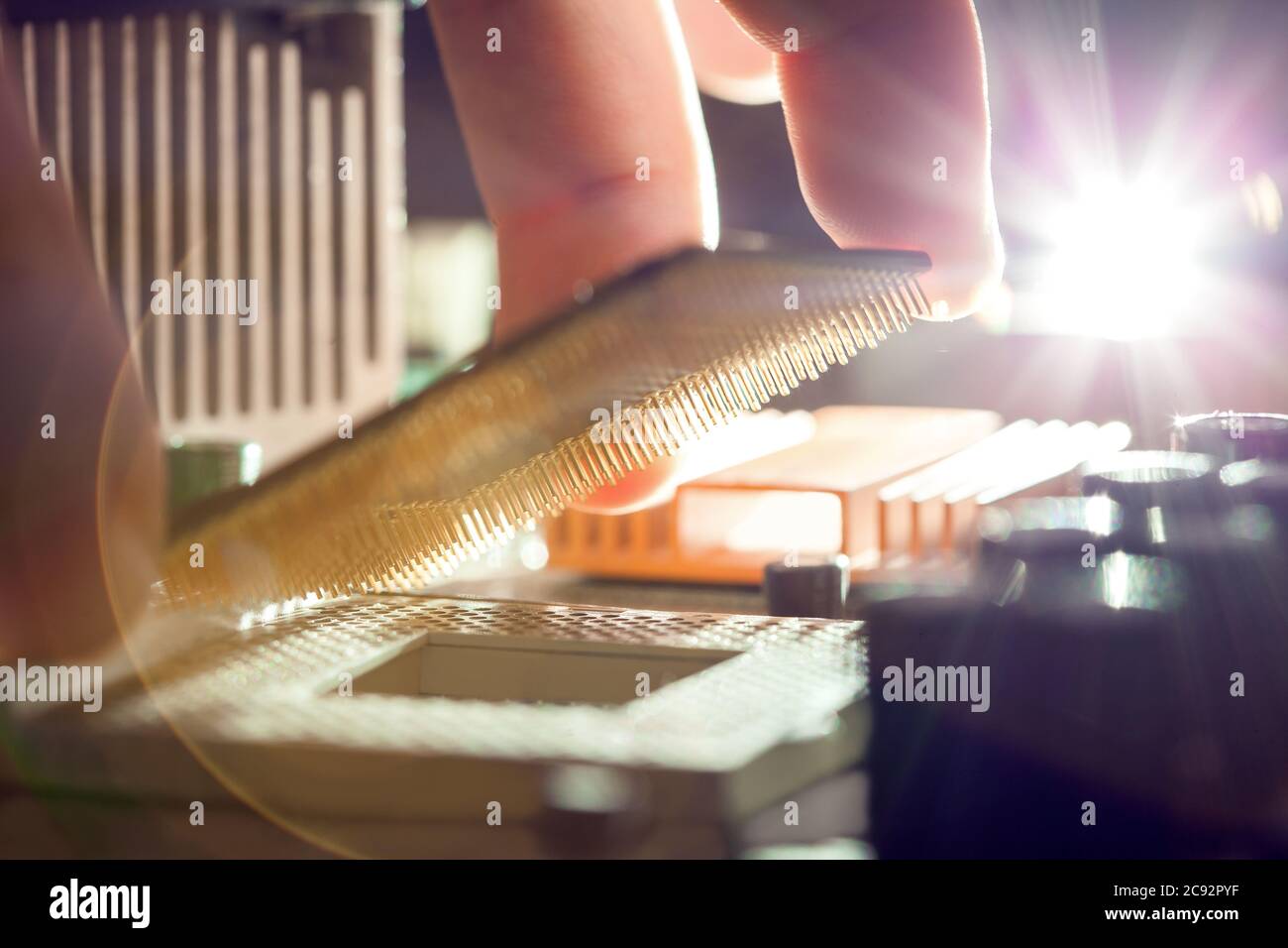 Technician plug in CPU microprocessor to motherboard socket, evident process of installation. Stock Photo