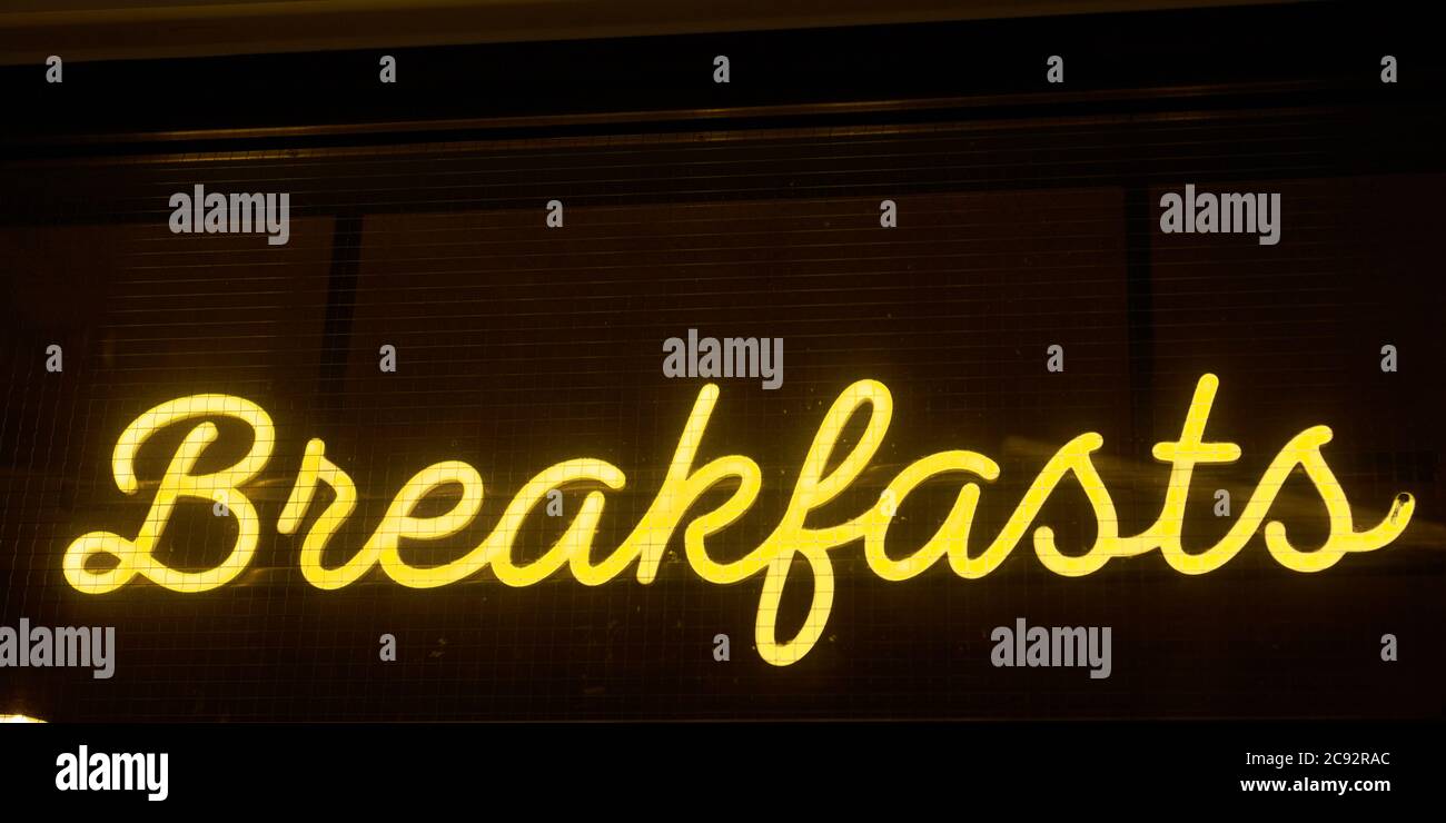 Neon sign reading Breakfasts outside of a restaurant  in the airside terminal of Luton Airport. Stock Photo