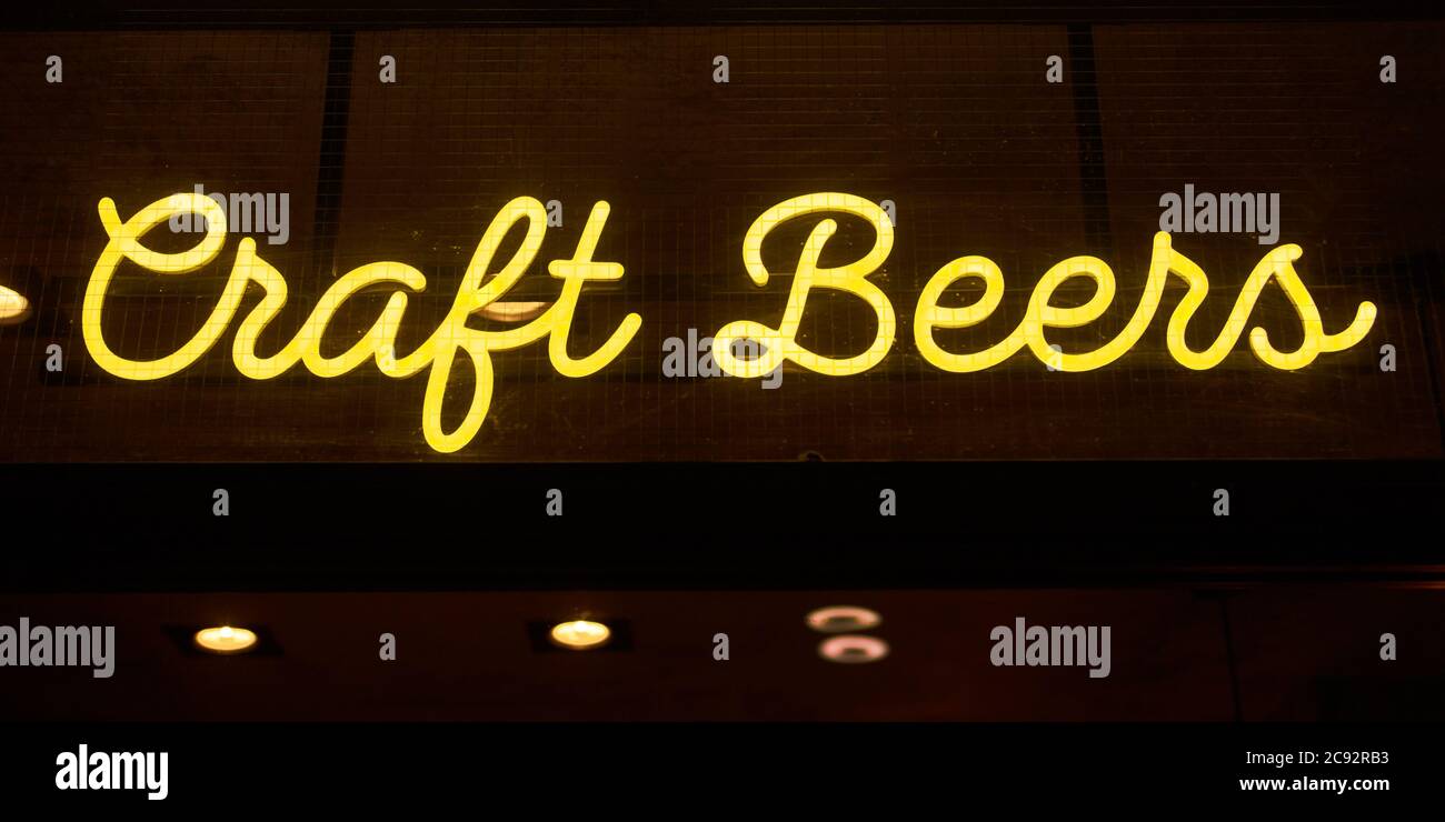 Neon sign reading Craft Beers outside of a restaurant  in the airside terminal of Luton Airport. Stock Photo
