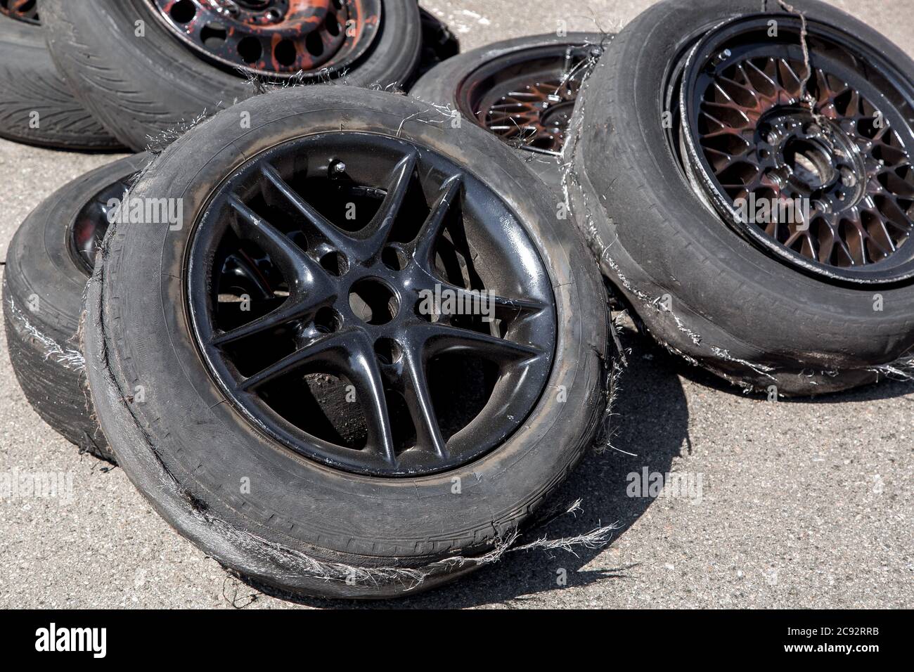 Stack up of used tires after drift racing, spoiled tire on black cast