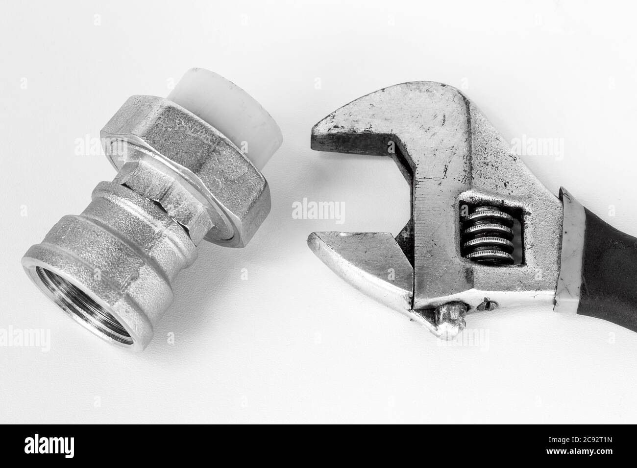 adjustable spanner and fitting for plastic pipes, on white background