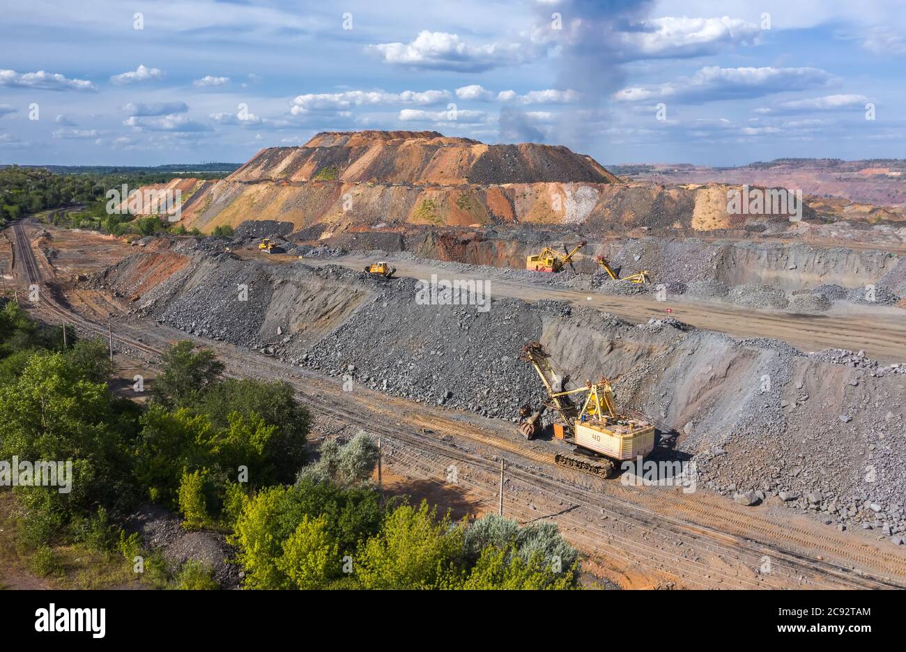 Quarry aggregate with heavy duty machinery. Construction industry aerial view. Stock Photo