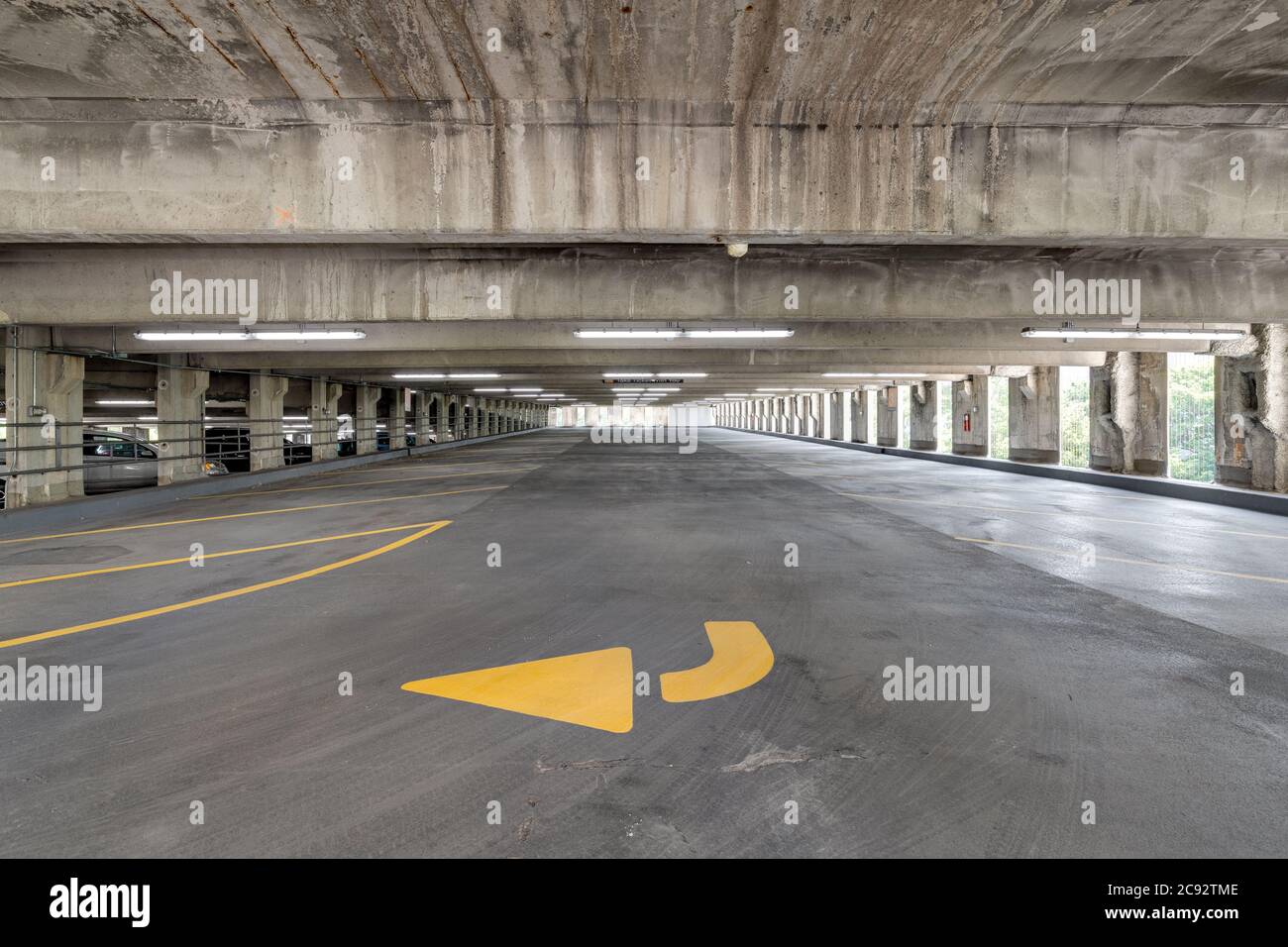 Empty parking garage with yellow lines for parking spaces and yellow
