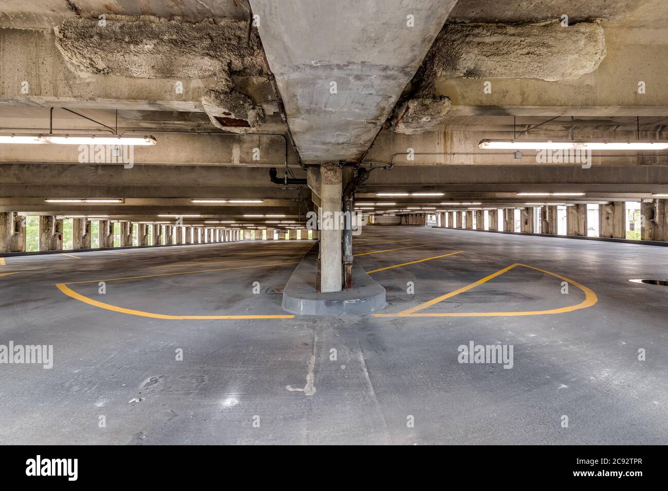 Empty parking garage with yellow lines for parking spaces Stock Photo