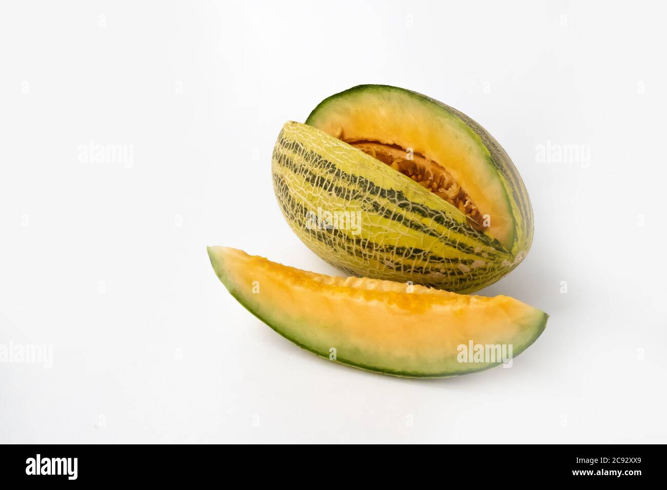 Striped yellow with green stripes an oblong melon with a carved slice