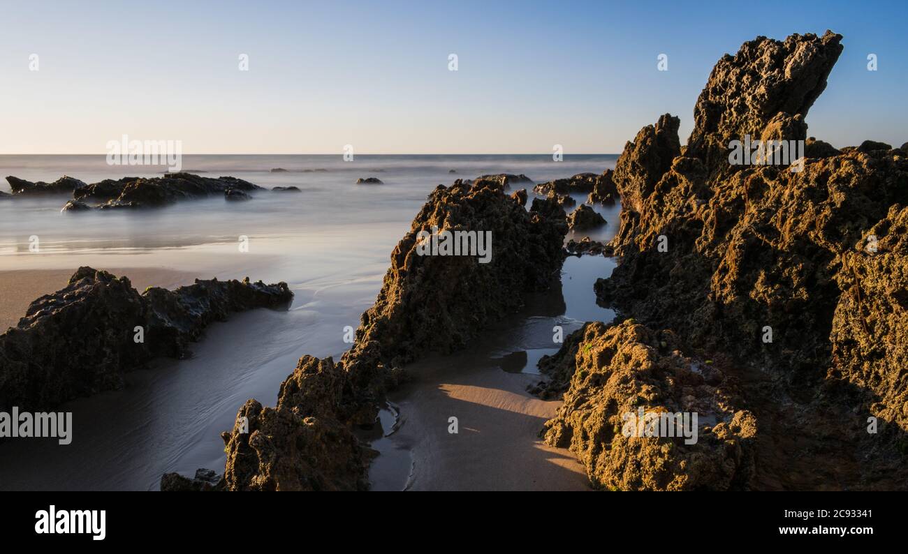 Light Beach Rocks light of the sunset illuminate the rocks on the beach Stock Photo - Alamy