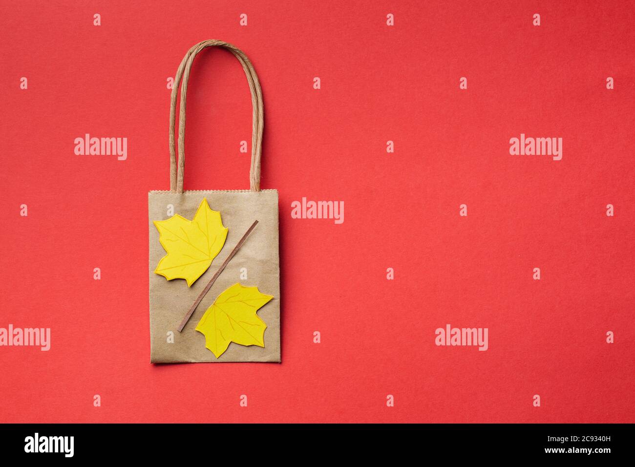 small paper bags with paper craft maple leaves autumn sale concept