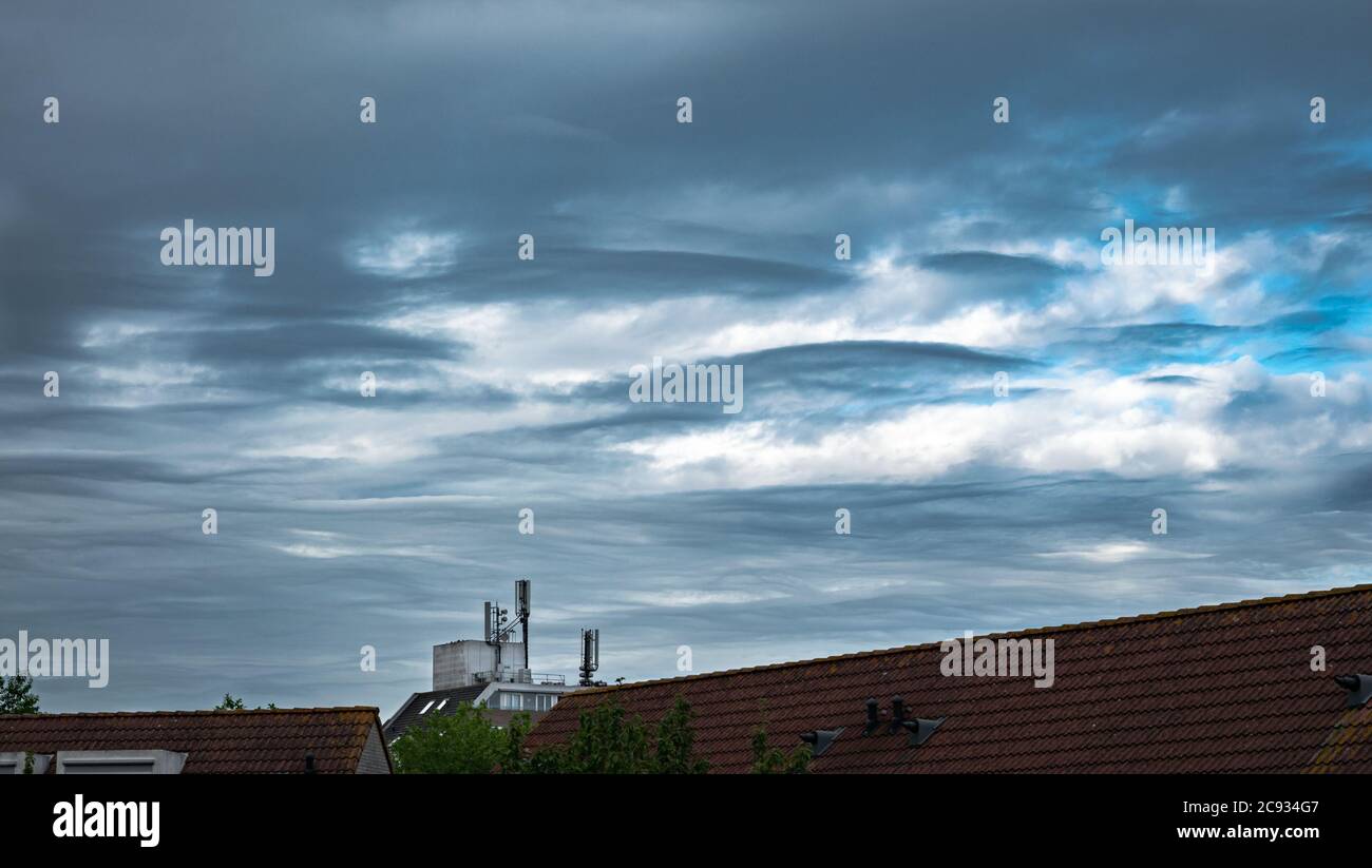 Wave clouds or lenticular clouds (Altocumulus lenticularis) in the sky Stock Photo