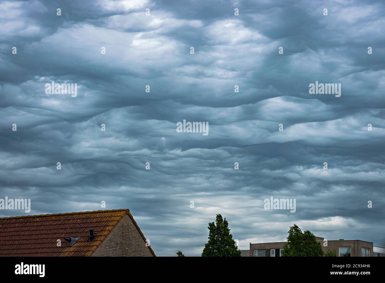Chaotic sky with bubble clouds. Scientific name of the clouds is altocumulus undulatus asperitas. Stock Photo