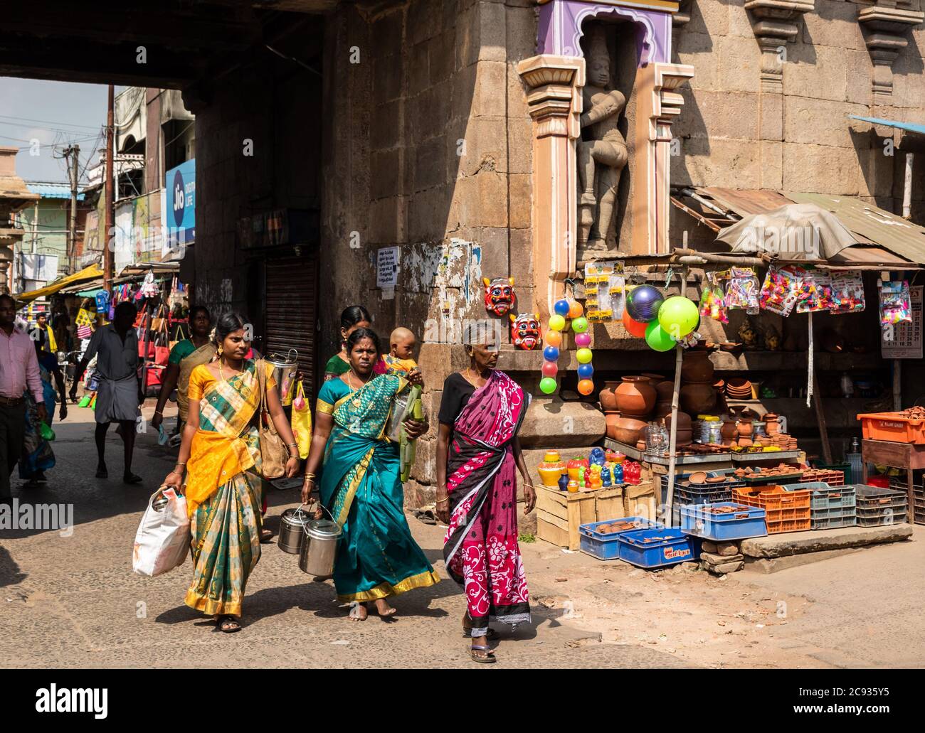 Trichy, Tamil Nadu, India - February 2020: Indian women in colorful saris walking in the market streets around the ancient Ranganathaswamy temple in S Stock Photo