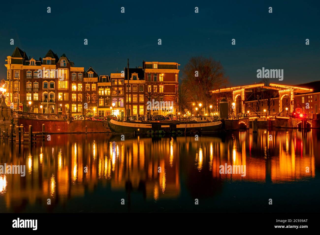 City scenic from Amsterdam at the river Amstel  in the Netherlands at night Stock Photo