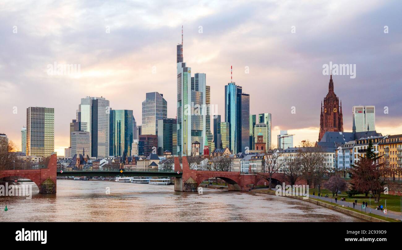 Frankfurt centre. Skyscapers of the Bankenviertel (Central Business Disctrict, CBD) and the Main river with the Alte Brucke during sunset. Germany. Stock Photo