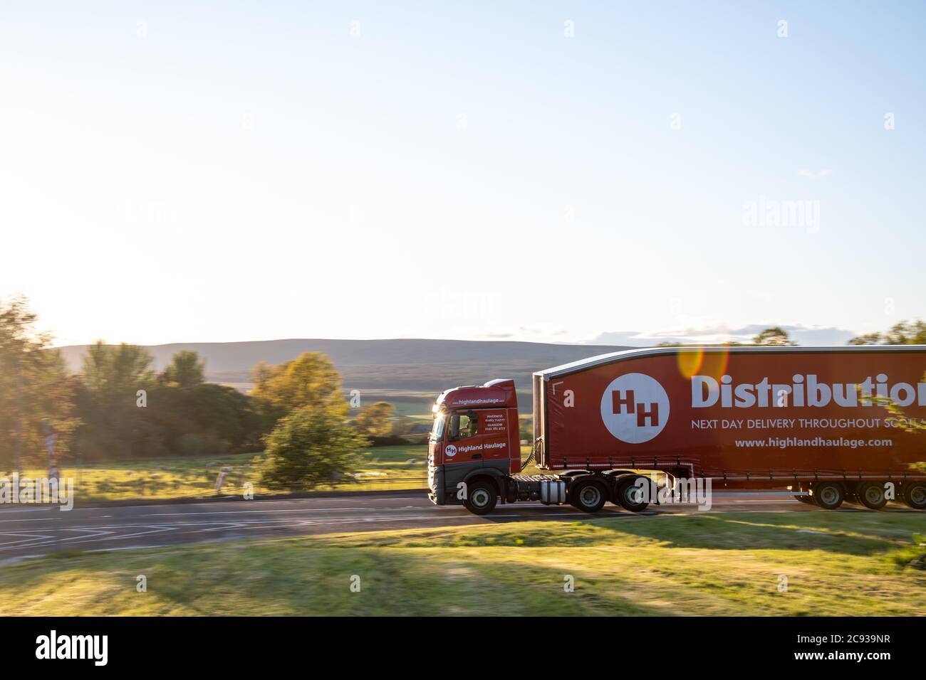 H H Distribution Mercedes Benz Actros with aerodynamic trailer driving along an A Road in Scotland Stock Photo