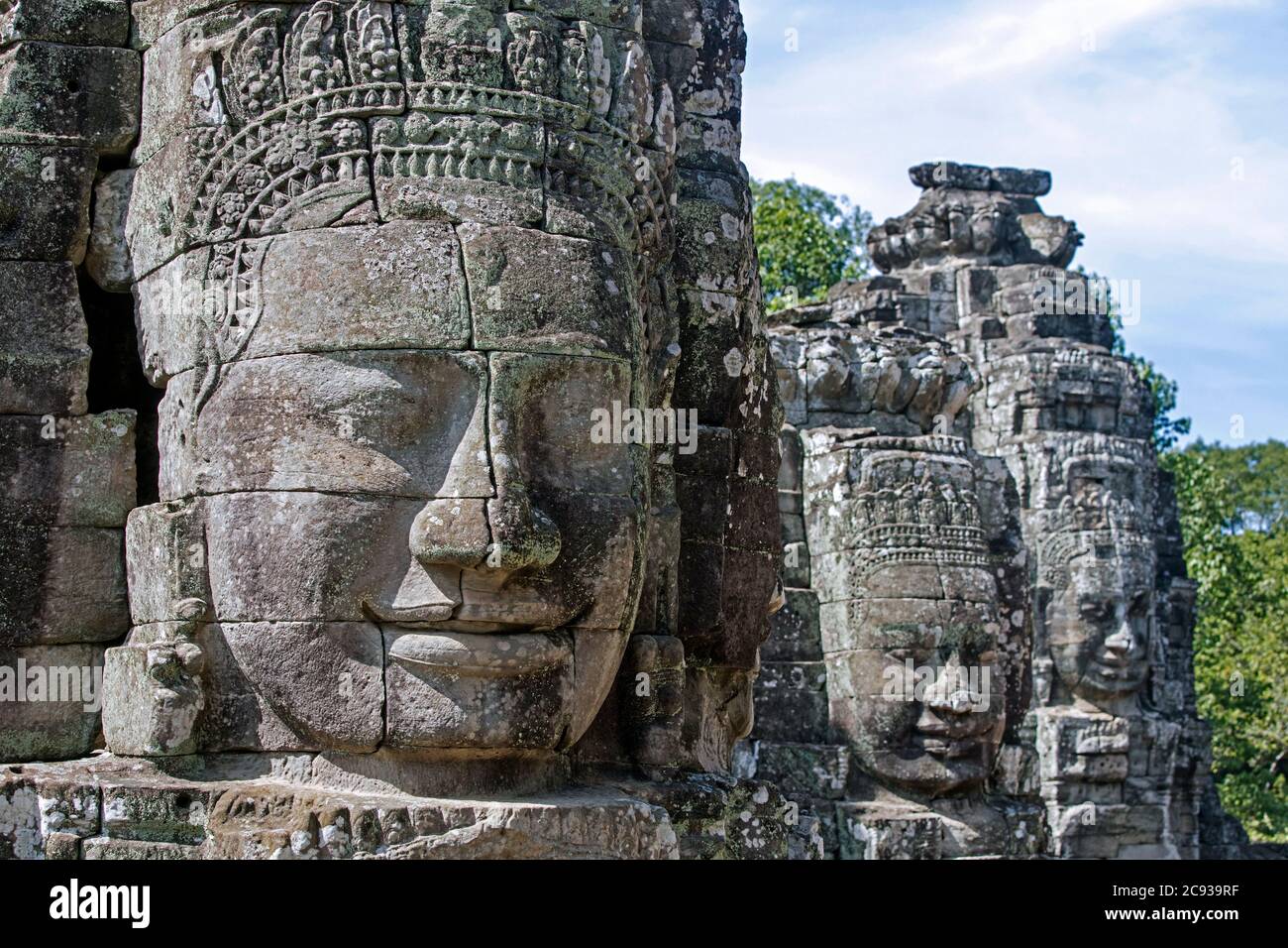 12th century stone faces at Angkor Thom / Nokor Thom, capital city of the Khmer Empire, Siem Reap, Cambodia Stock Photo