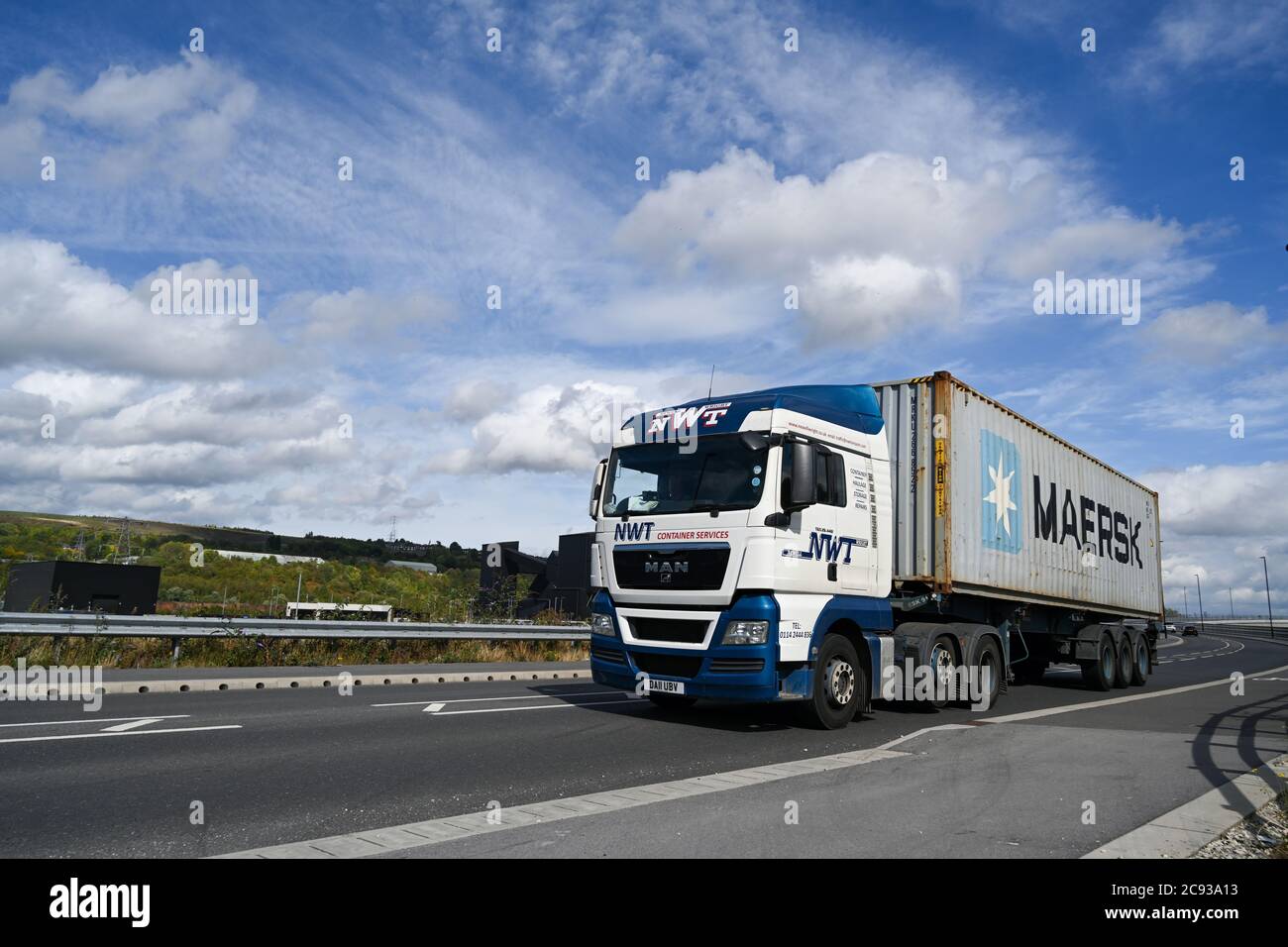 A Newell and Wright MAN container truck driving along a dual carriageway in Tinsley, Sheffield, South Yorkshire Stock Photo