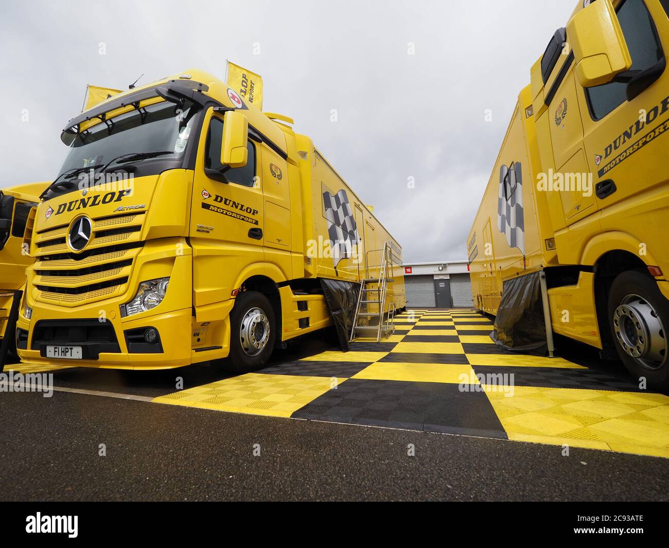 Dunlop Mercedes Benz Actros support trucks and trailer workshop parked in  the paddock at Silverstone race track during a Supermoto bike racing event  Stock Photo - Alamy