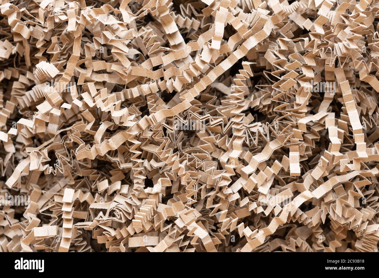 shredded paper - zig zag or crinkle cut shredded brown paper packing material Stock Photo