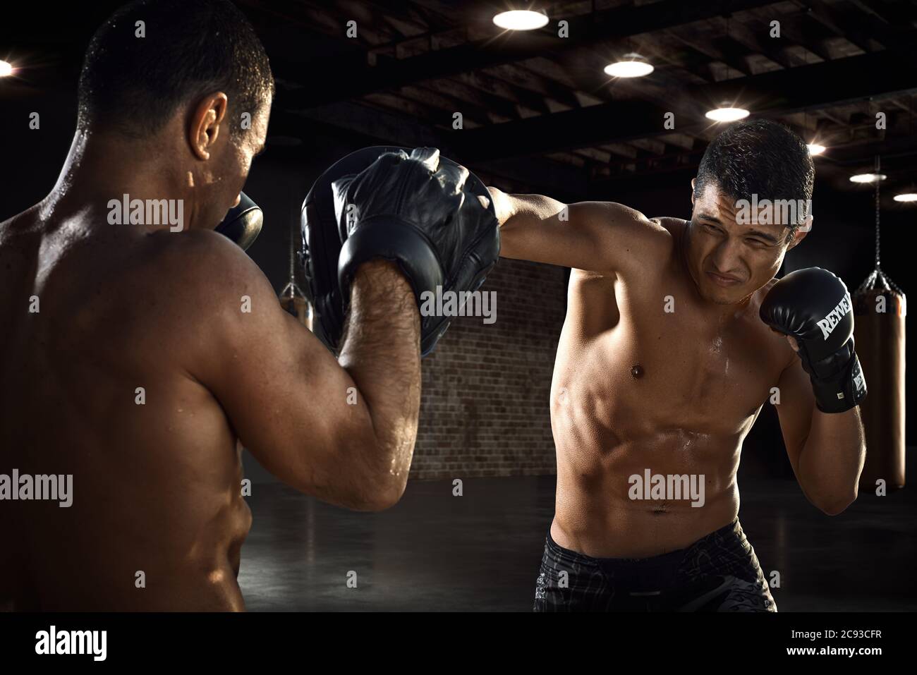 Fighter is training his boxing skills with a coach in a gym. Boxing, mma,  wrestling, karate. Young, strong, muscular athlete Stock Photo - Alamy