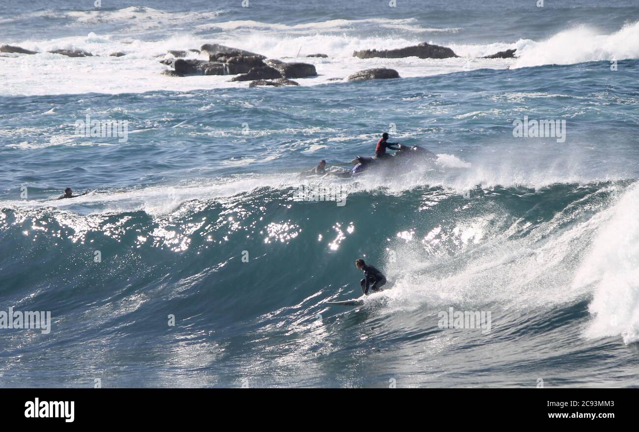 SYDNEY, AUSTRALIA - May 25, 2016: Big Wave Rider in Australia in a perfect blue day with jet ski Stock Photo