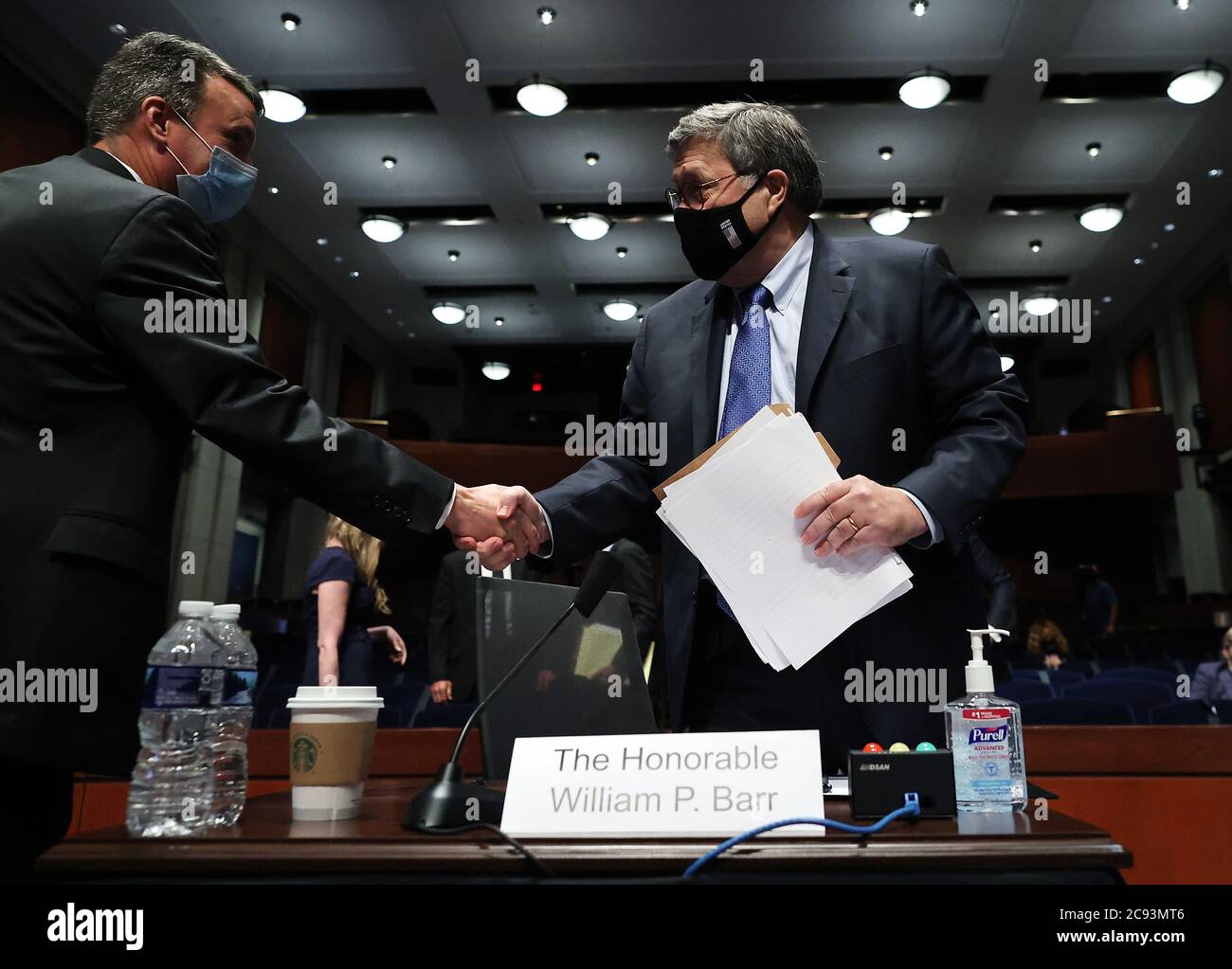 United States Attorney General William P. Barr, right, shakes hands with US Representative Ben Cline (Republican of Virginia), left, during a break in a US House Judiciary Committee hearing on Capitol Hill on July 28, 2020 in Washington, DC. In his first congressional testimony in more than a year, Barr faced questions from the committee about his deployment of federal law enforcement agents to Portland, Oregon, and other cities in response to Black Lives Matter protests; his role in using federal agents to violently clear protesters from Lafayette Square near the White House last month befor Stock Photo