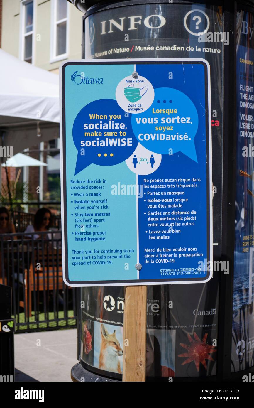 Ottawa Health sign highlighting Social behaviour in Covid times when going out, at entrance of Byward Market Restaurant area Stock Photo