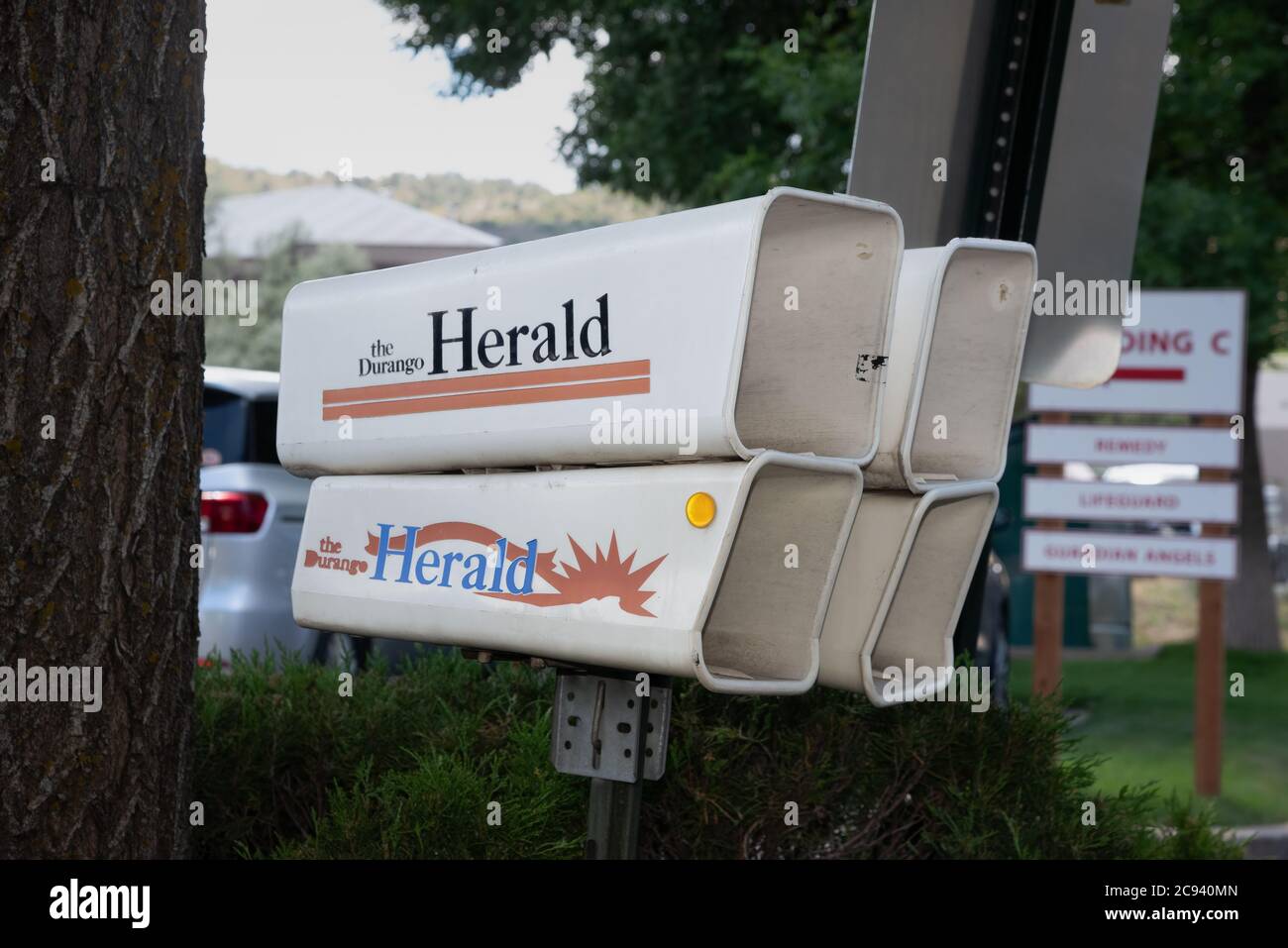 Four empty plastic newspaper delivery tube boxes for the Durango Herald