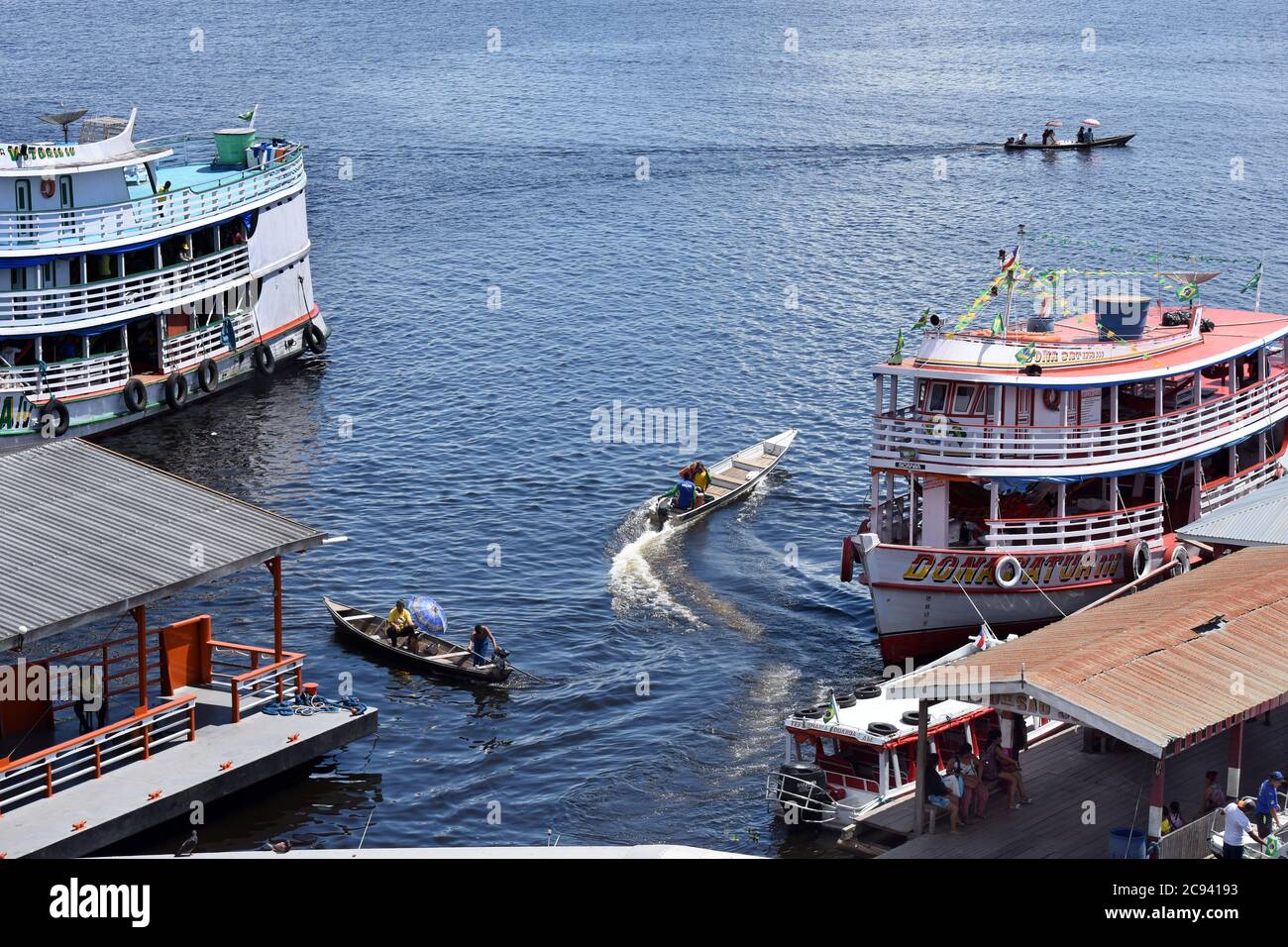 A mix of boat types at the ferry terminal in Tefé, a riverport on the Upper Amazon in Brazil Stock Photo