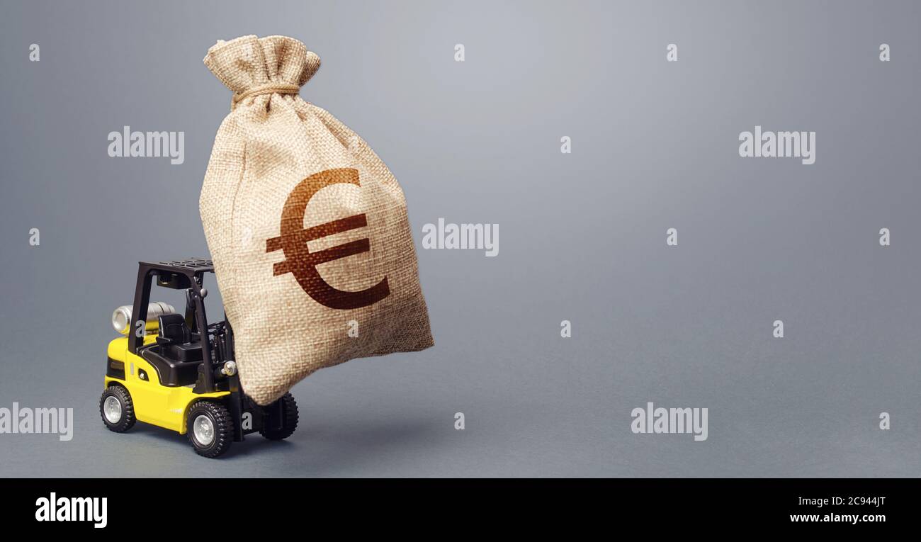 A forklift carrying a huge euro money bag. EU anti-crisis budget. Borrowing on capital market. Stimulating economy. Subsidies soft loans. Strongest fi Stock Photo