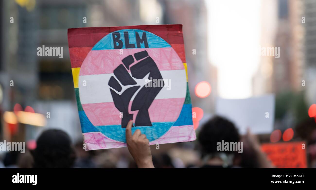 Black Womens/Womxn March Black Lives Matter Protest - BLM Black Power Fist sign in crowd Stock Photo
