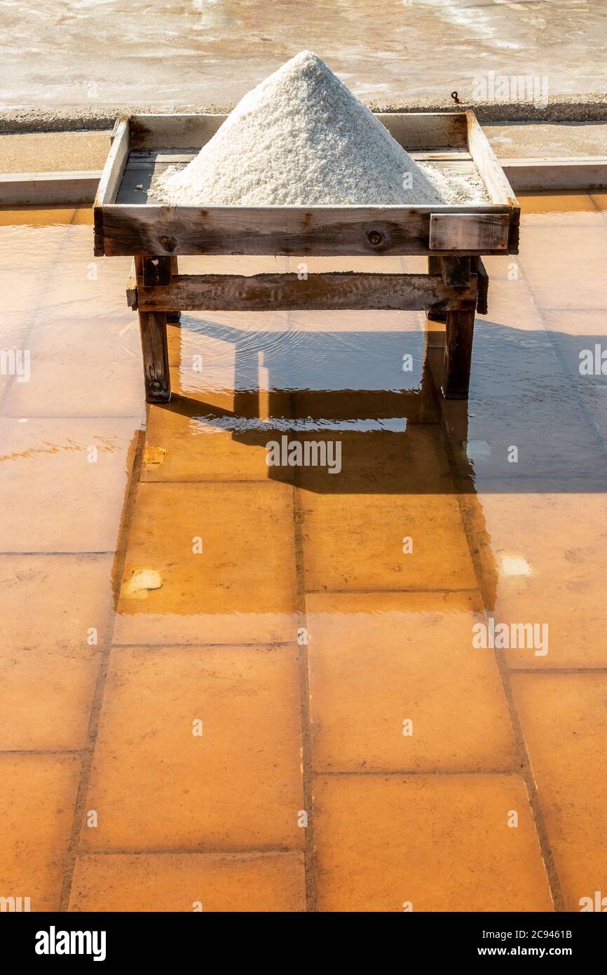 Heap of salt on top of wooden structure in the salt flats of Rio Maior, Portugal, on a sunny day. Stock Photo