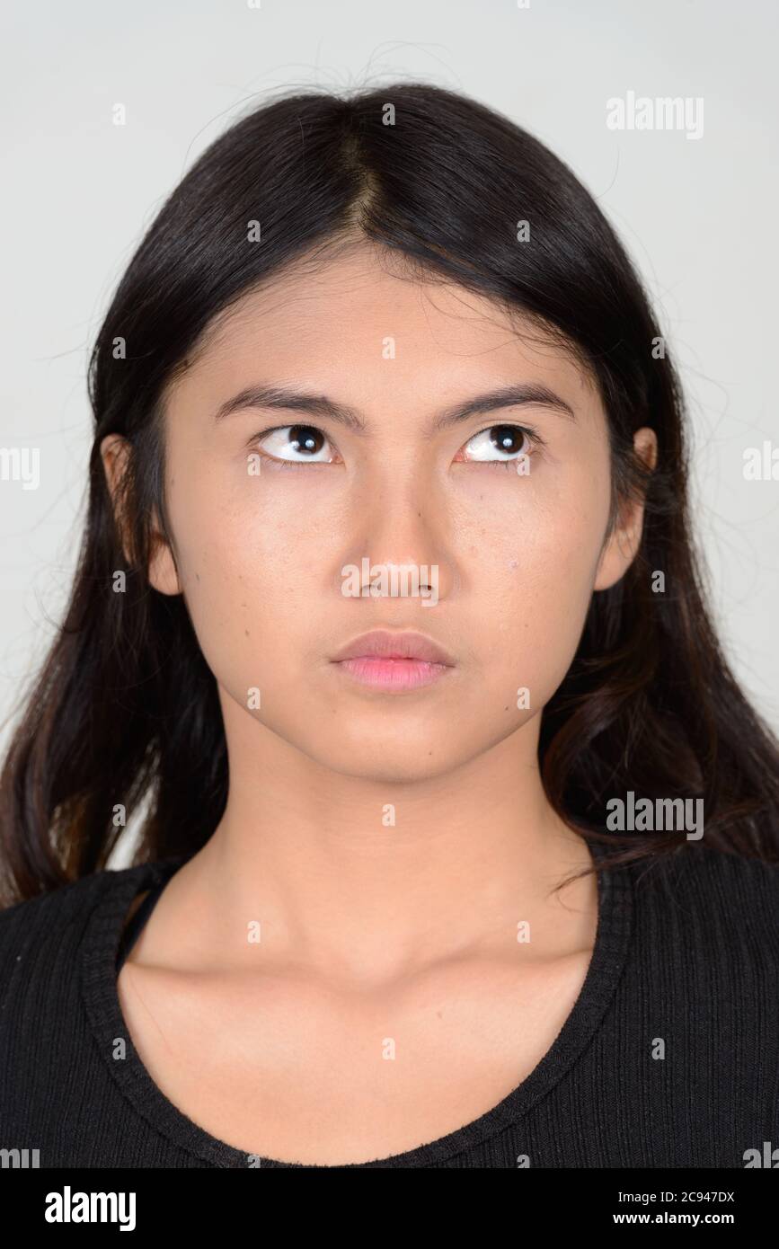Portrait of young beautiful Asian woman thinking Stock Photo - Alamy