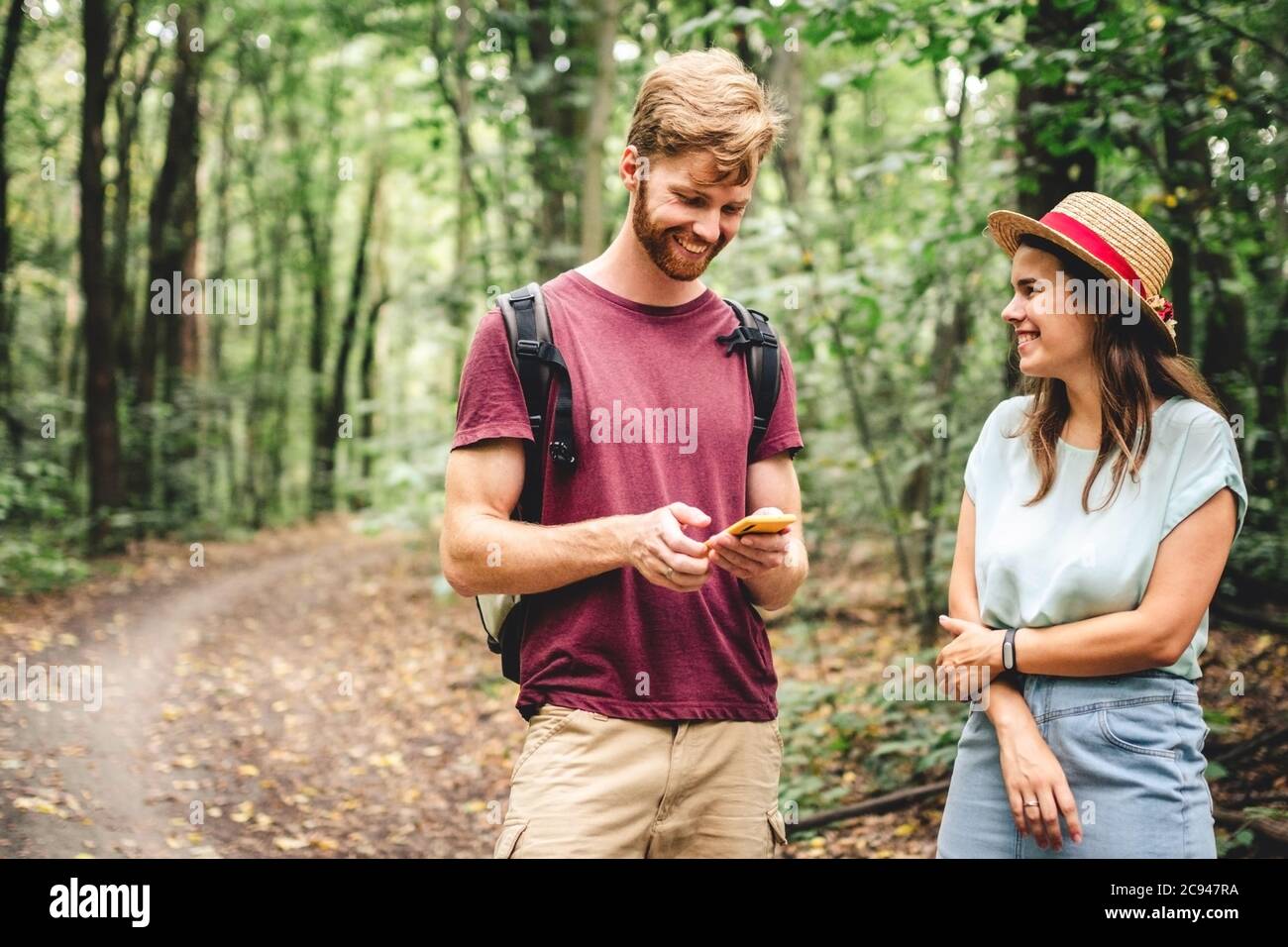 Hikers using mobile gps for directions. Happy couple checking