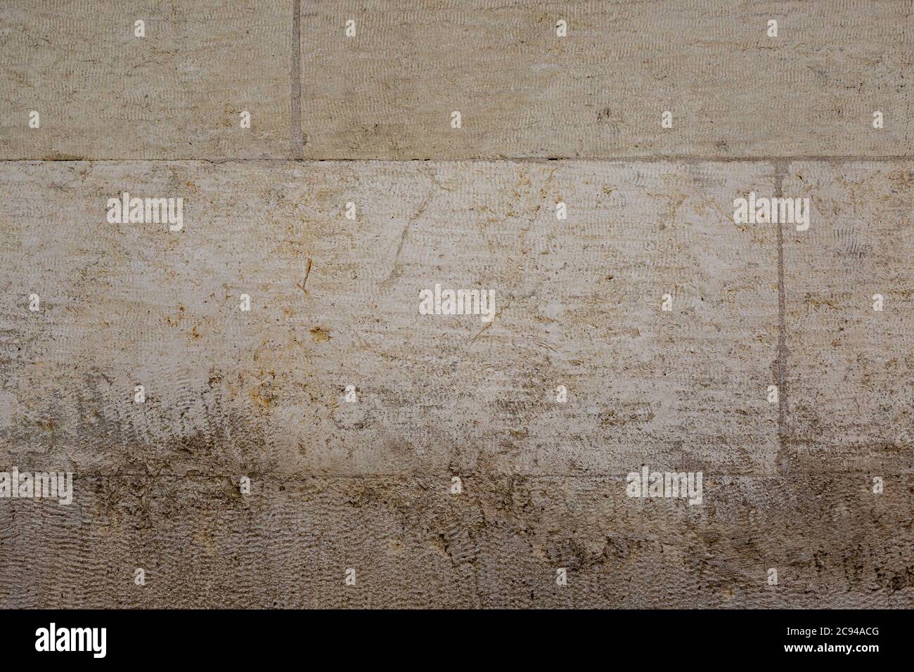 Gray colored lime stone wall texture. Brushed blocks with flat cuts. Stock Photo