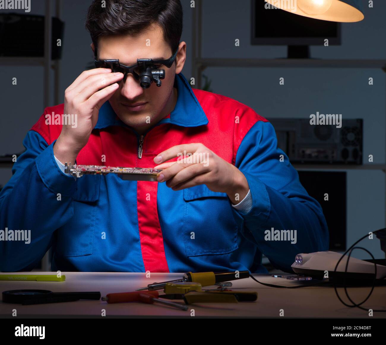The computer specialist repairing pc late at night Stock Photo - Alamy