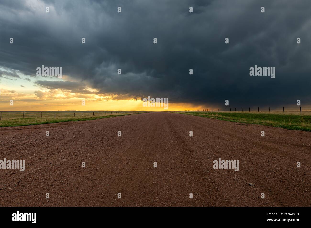 Panorama of a massive mesocyclone weather supercell, which is a pre-tornado stage, passes over a grassy part of the Great Plains while fiercely trying Stock Photo