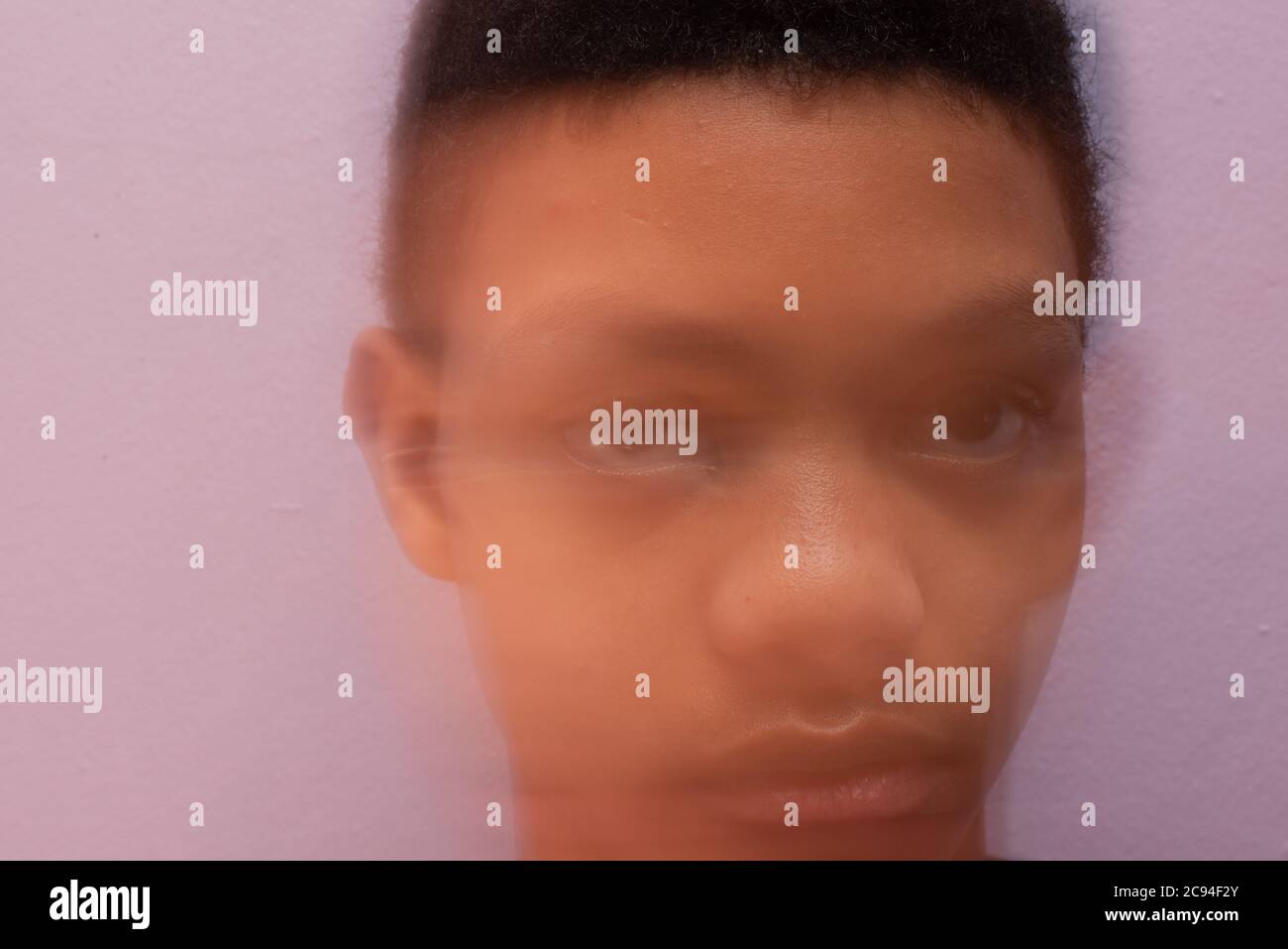 Sad looking teenager shot up close with motion blur Stock Photo
