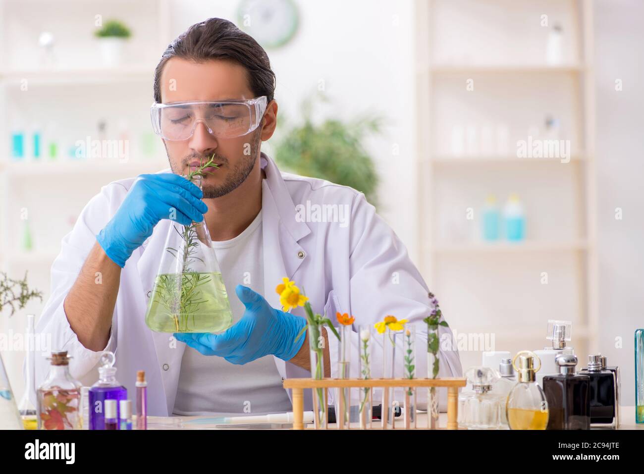 Young chemist in perfume synthesis concept Stock Photo Alamy