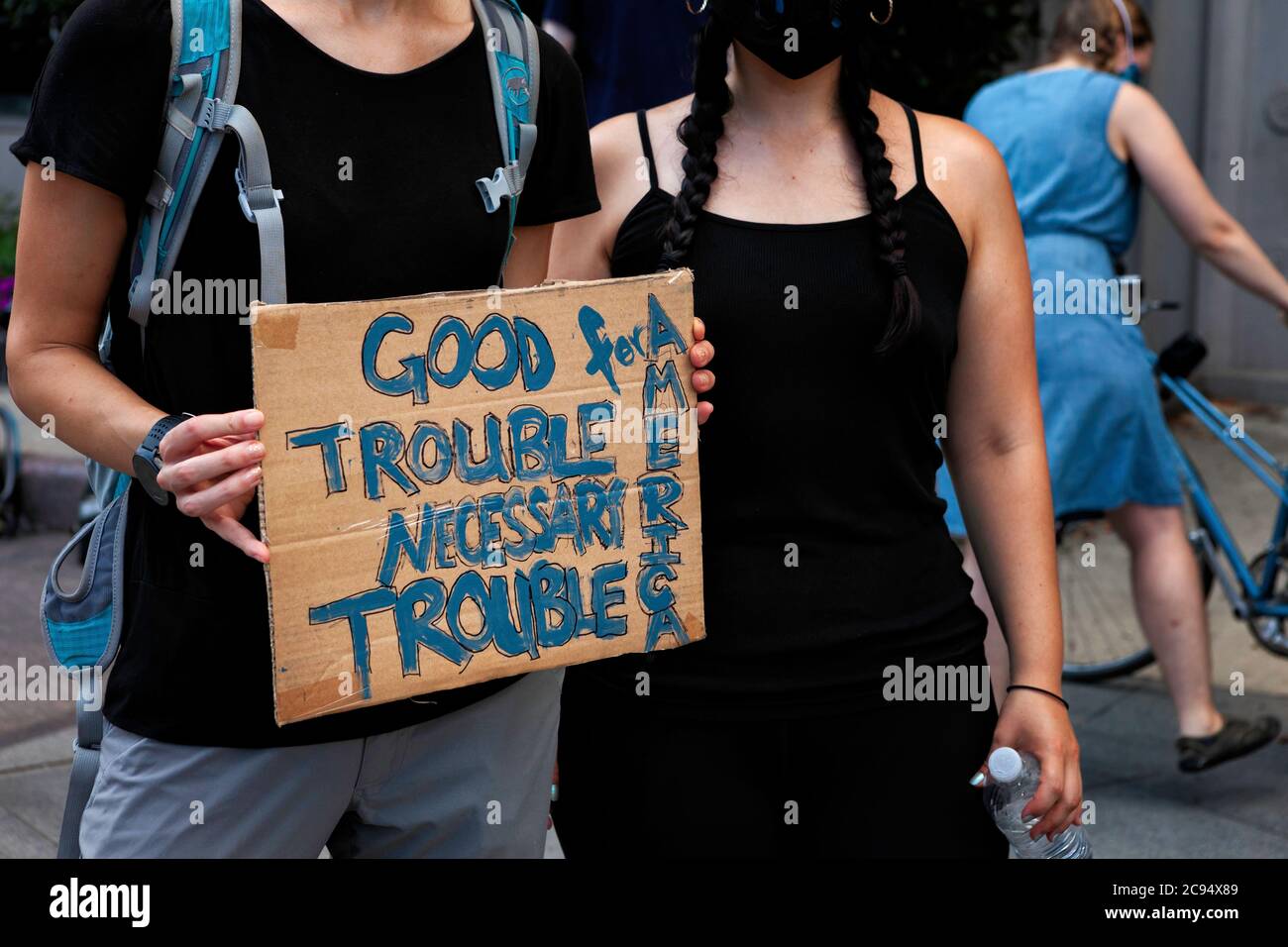 A sign quoting Congressman John Lewis: 'Good trouble, necessary trouble' at the March Against Trump's Police State, Washington, DC, United States Stock Photo