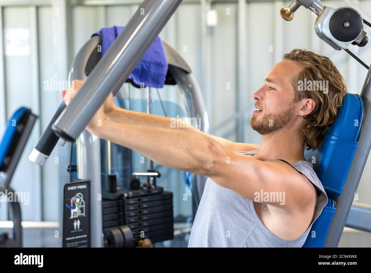 Man exercising at gym. Fitness athlete doing chest exercises on