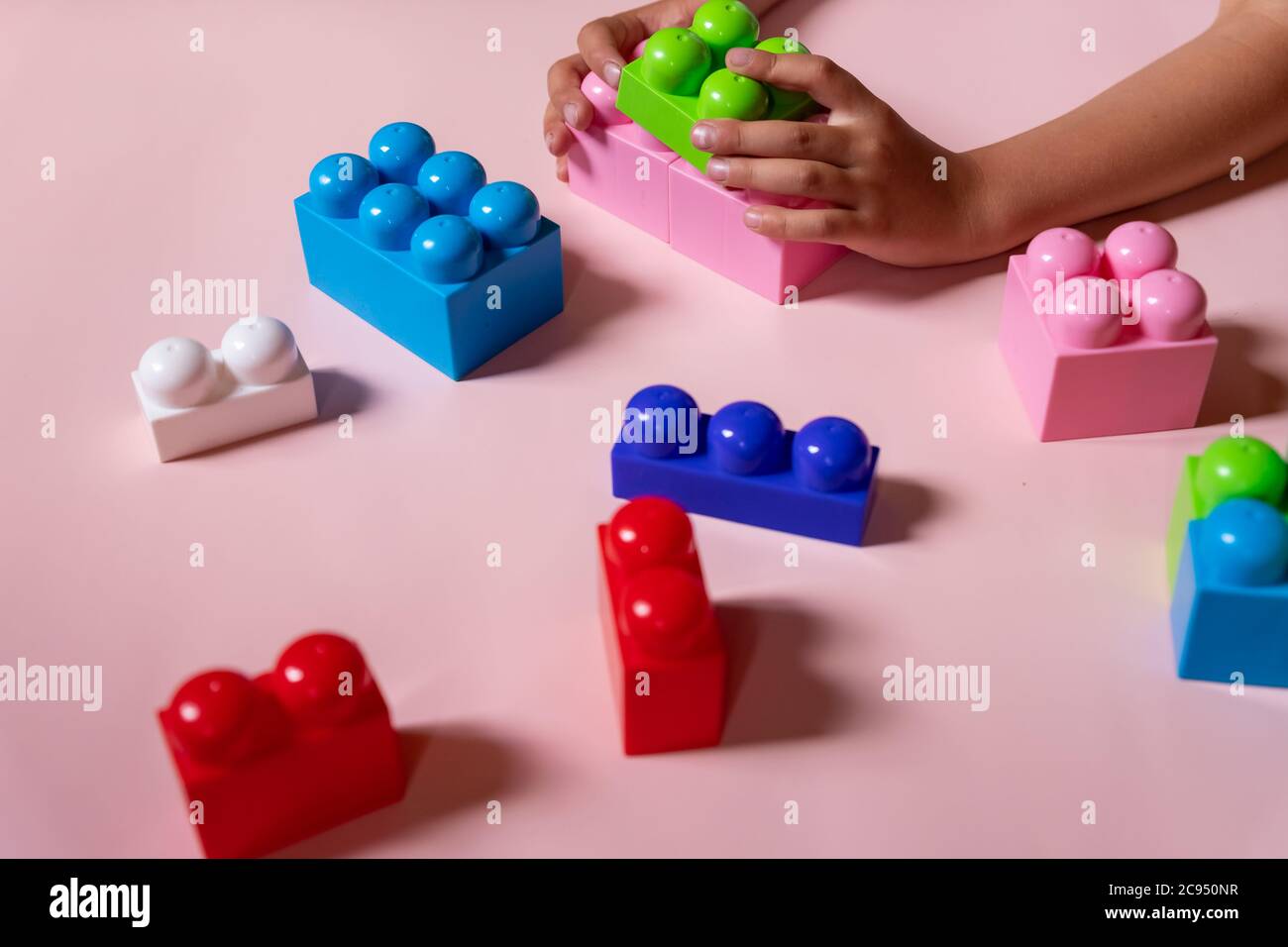 lchild playing with construction toy blocks, building a tower in